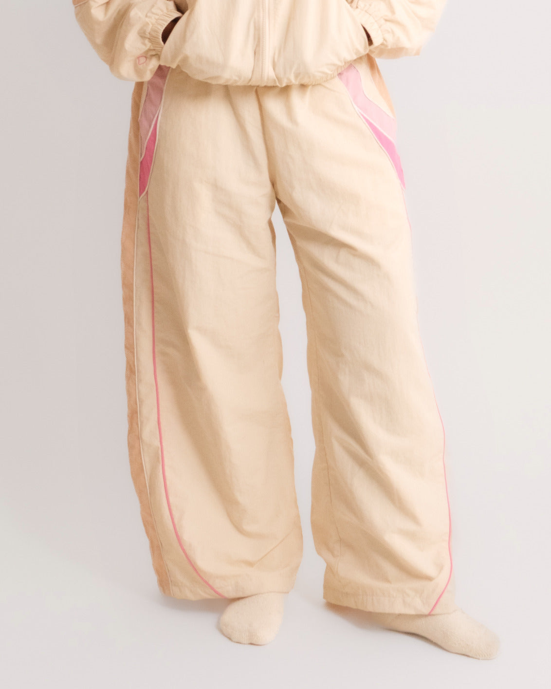 Woman in the Sweets Track Pants in Rose Pink with the matching Track Jacket, front view #Color_Rose Pink