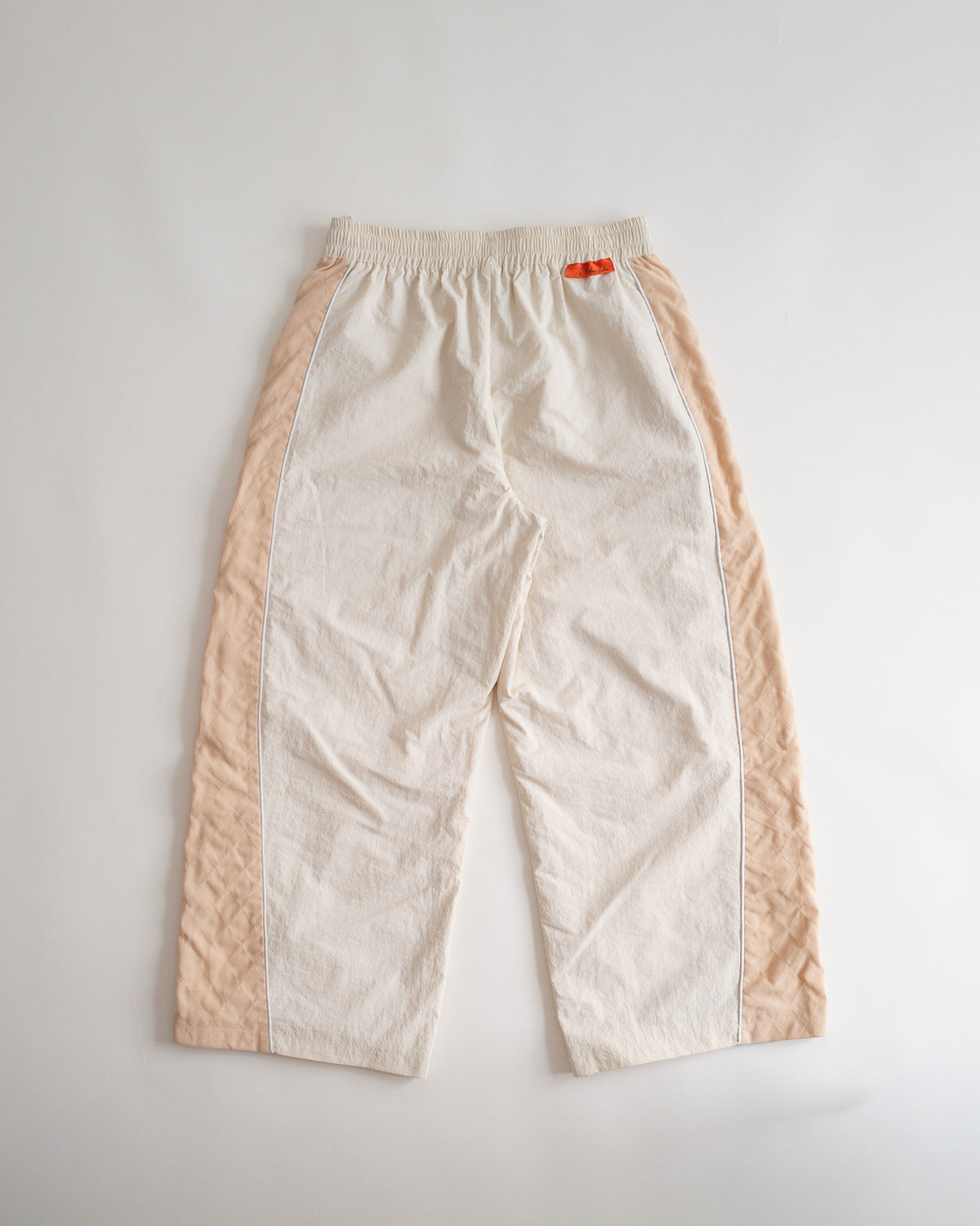 Sweets Track Pants in Saffron Orange, flat lay from the back #Color_Saffron Orange