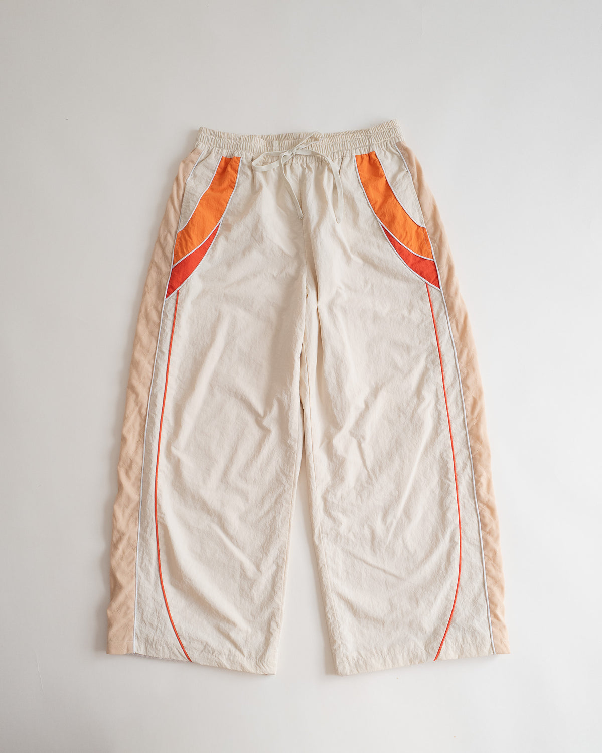 Sweets Track Pants in Saffron Orange, flat lay from the front #Color_Saffron Orange