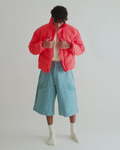 Video of a man in the Jalebi Down Jacket with the Khadi Katli Jorts, spiral quilting across the back
