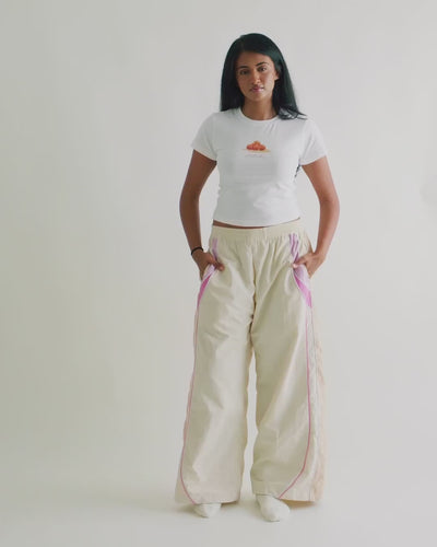 Video of a woman in the Sweets Baby Tee with the Sweets Track Pants in Rose Pink