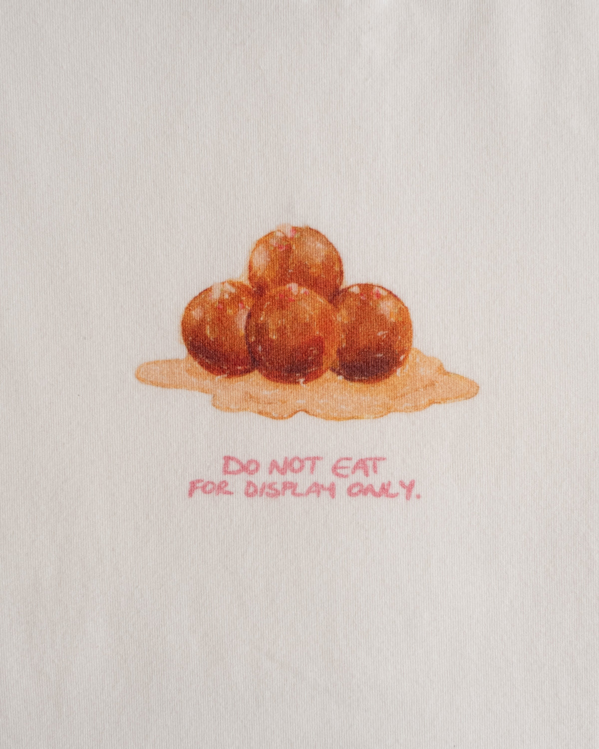 Close-up of the gulab jamun print and the line: do not eat, for display only #Color_Gulab Jamun