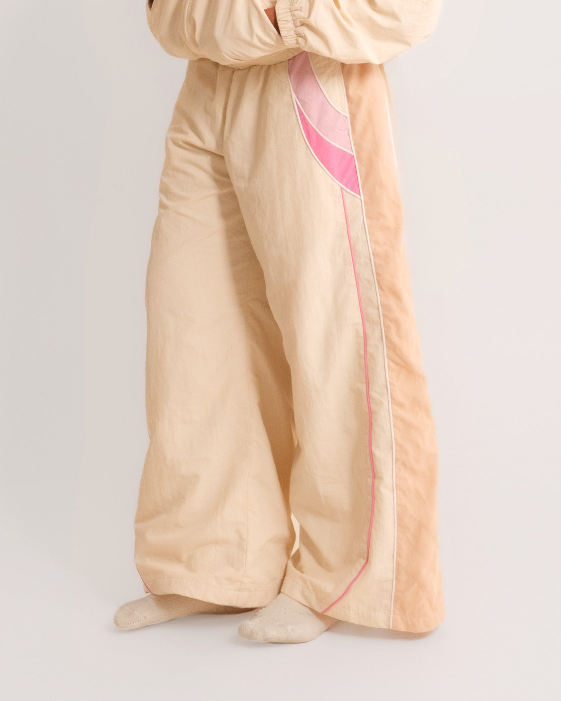 Side view of the Rose Pink Sweets Track Pants, baggy barrel leg #Color_Rose Pink