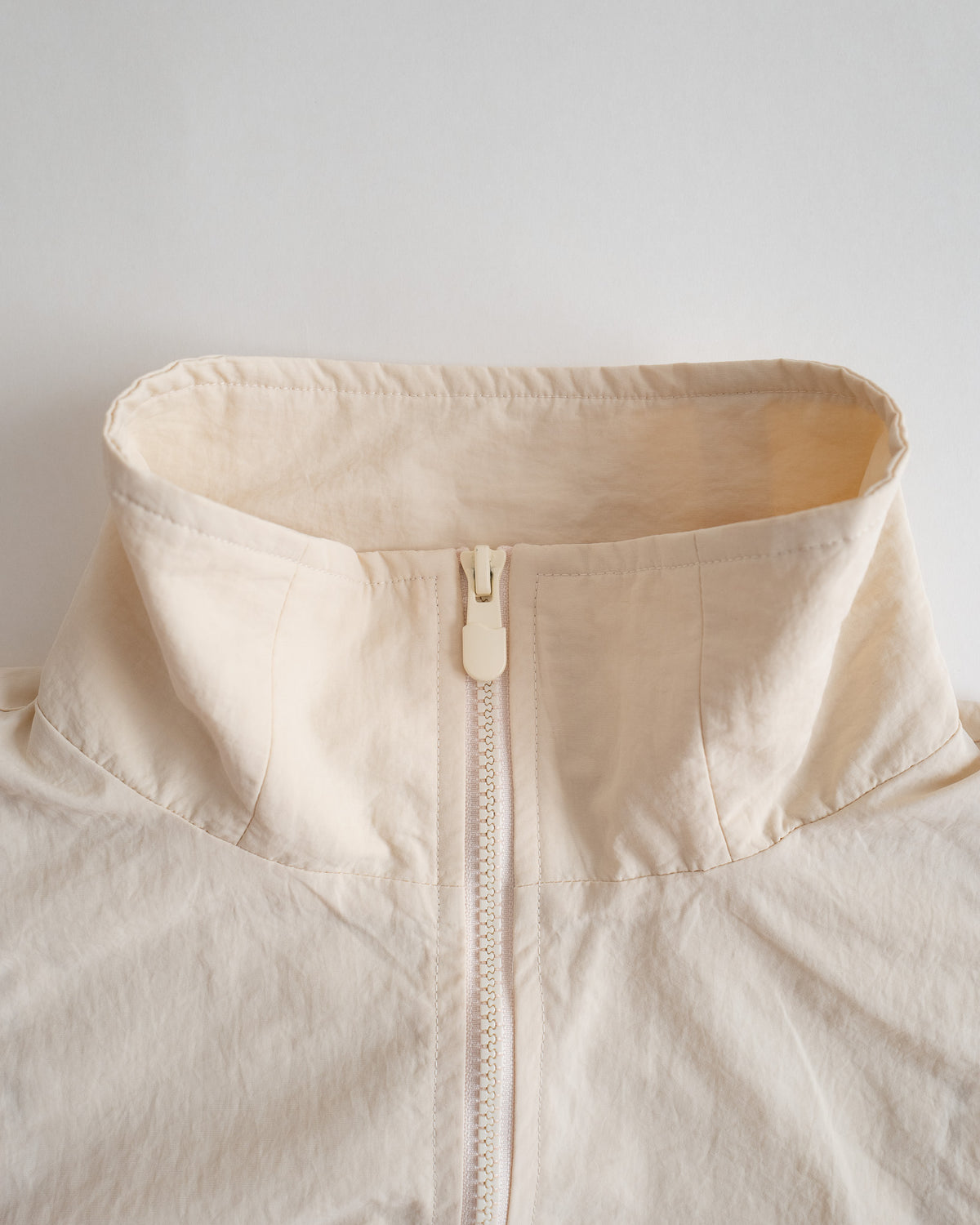 Close-up of the tall collar and full zip on the Sweets Track Jacket
