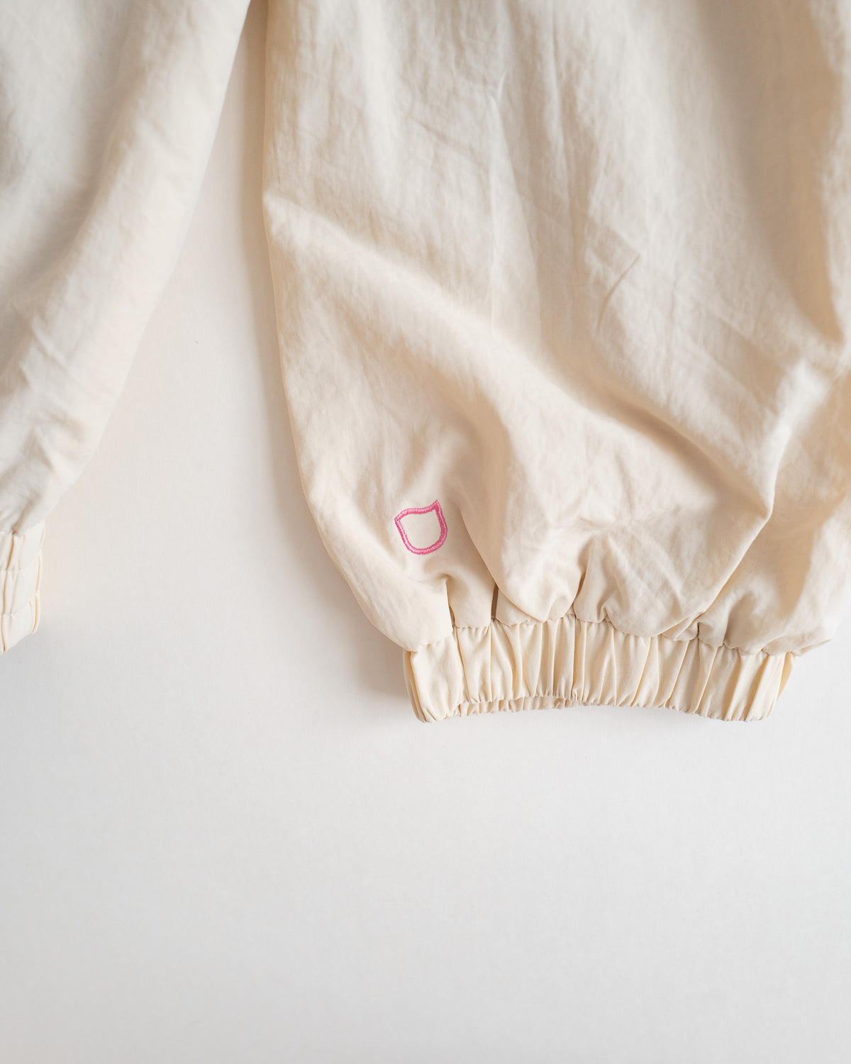 Close-up of the elastic cuff on the Sweets Track Jacket with a small embroidered mark in rose pink #Color_Rose Pink