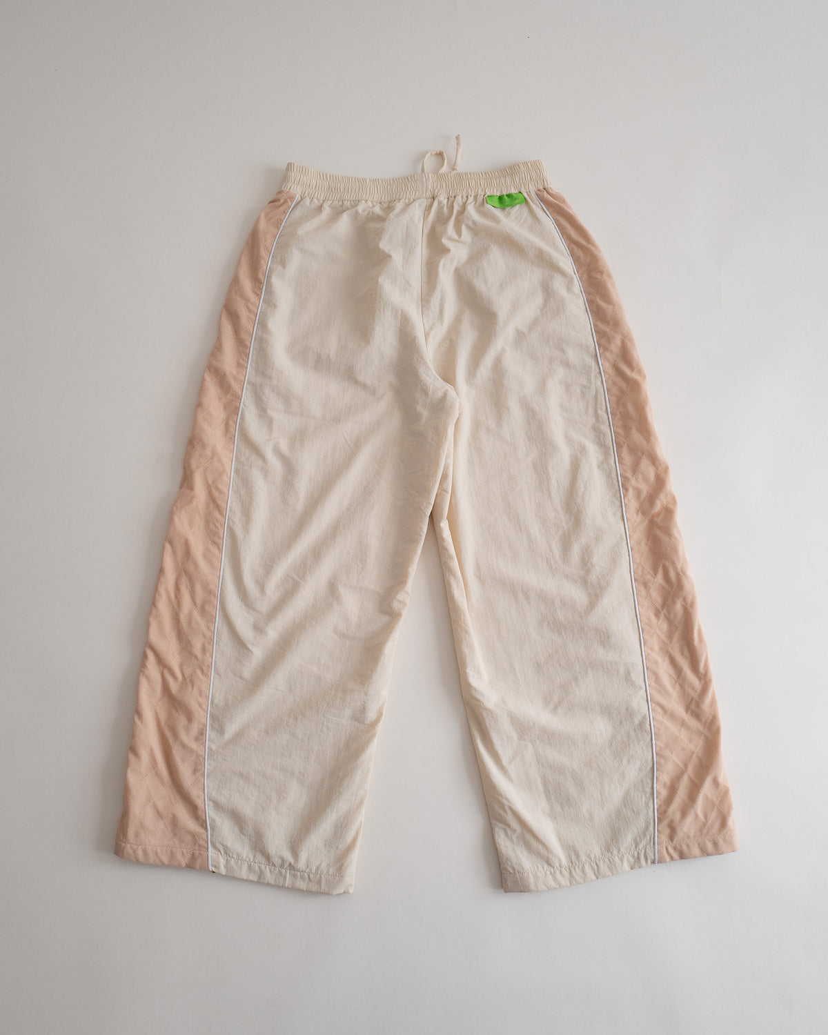 Sweets Track Pants in Pista Green, flat lay from the back #Color_Pista Green